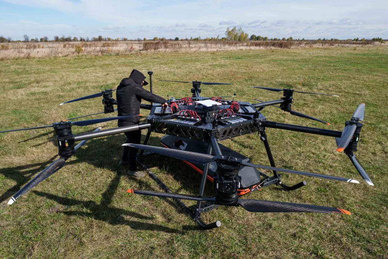 A representative of the SkyFall drone company checks the StarGate drone before a demonstration flight at an undisclosed location in Ukraine, Wednesday, Oct. 14, 2026. (AP Photo/Evgeniy Maloletka) CORRECTION: Corrects name of drone to StarGate instead of SkyGate License this photo